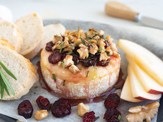 Baked Brie with Cranberries and Walnuts plated with bruchetta and fruit