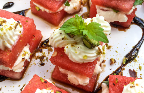 delicious watermelon bites with feta and basil on a classic white tray